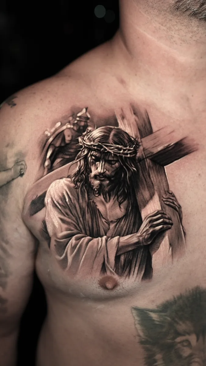 Jesus carrying cross chest tattoo by Ramon Rodrigo